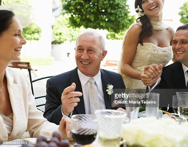 bride and groom at table with parents, smiling - maria weding stock pictures, royalty-free photos & images
