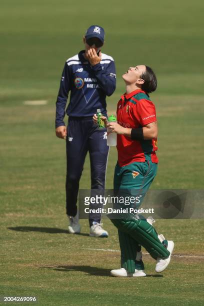 Heather Graham of Tasmania rinses her mouth after drinking pickle juice to treat cramping during the WNCL match between Victoria and Tasmania at...