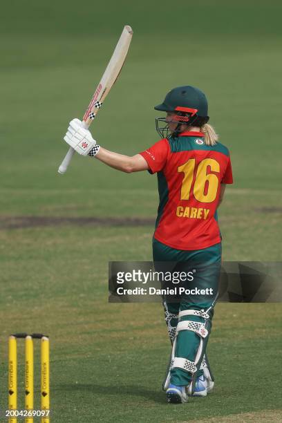 Nicola Carey of Tasmania raises her bat to celebrate making fifty runs during the WNCL match between Victoria and Tasmania at CitiPower Centre, on...