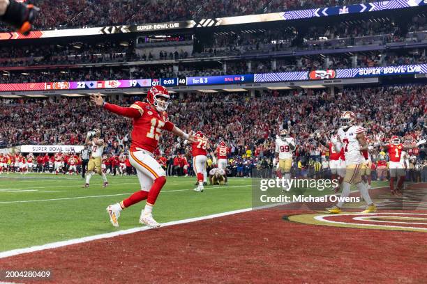 Patrick Mahomes of the Kansas City Chiefs runs into the end zone as he celebrates after passing to Mecole Hardman Jr. #12 of the Kansas City Chiefs...