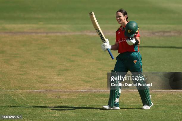 Heather Graham of Tasmania raises her bat to celebrate making a century during the WNCL match between Victoria and Tasmania at CitiPower Centre, on...