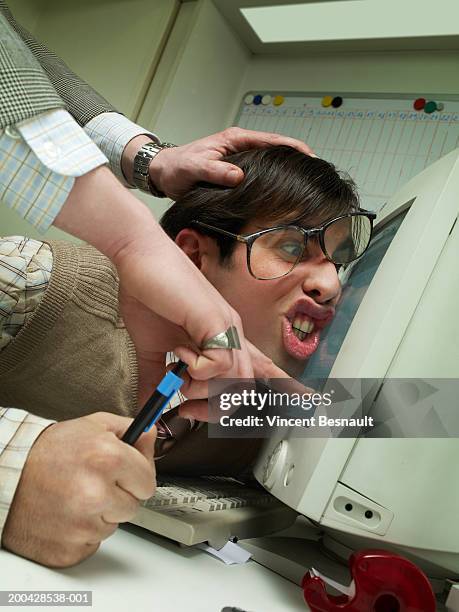 manager pushing office worker's face against computer screen - gesture control screen imagens e fotografias de stock