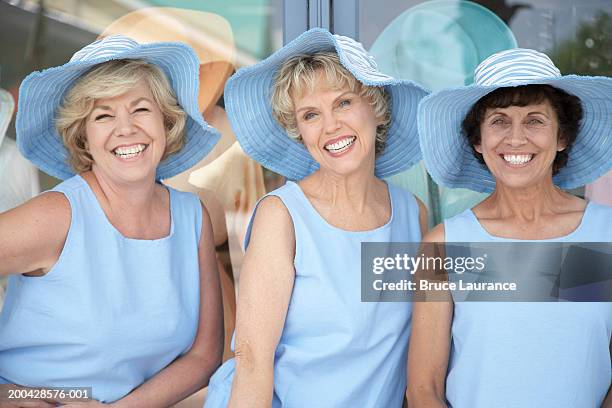 three senior women wearing the same outfit smiling, portrait - matching outfits stock pictures, royalty-free photos & images