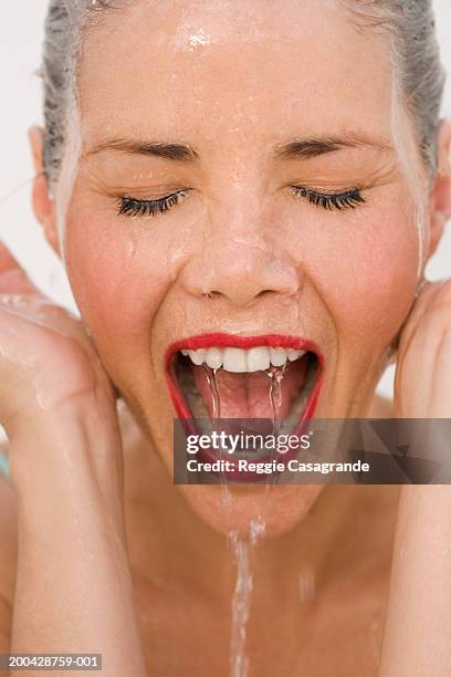 woman splashing water on face, eyes closed, mouth open - woman face cleaning stock pictures, royalty-free photos & images