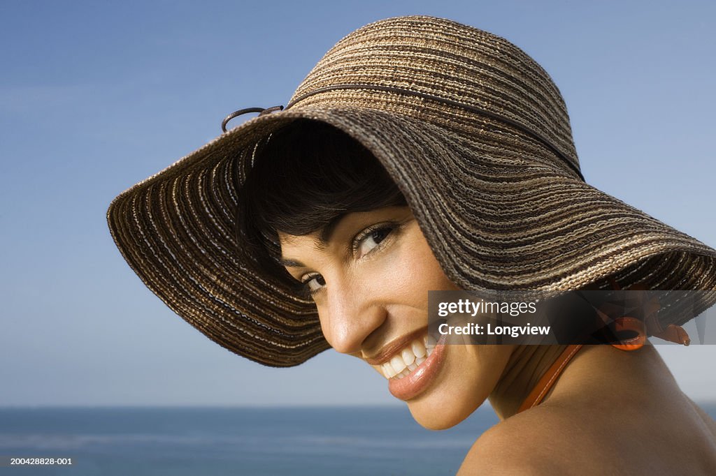 Woman wearing brown hat, smiling