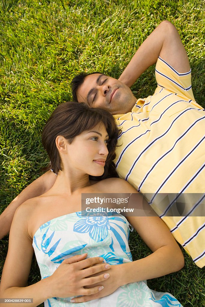 Couple lying on grass, elevated view