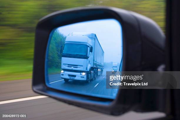 lorry reflected in car wing mirror travelling in rain (blurred motion) - side view mirror stock pictures, royalty-free photos & images