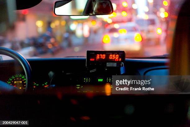 cab meter on dashboard, view from car interior, night (focus on meter) - taxi cab photos et images de collection