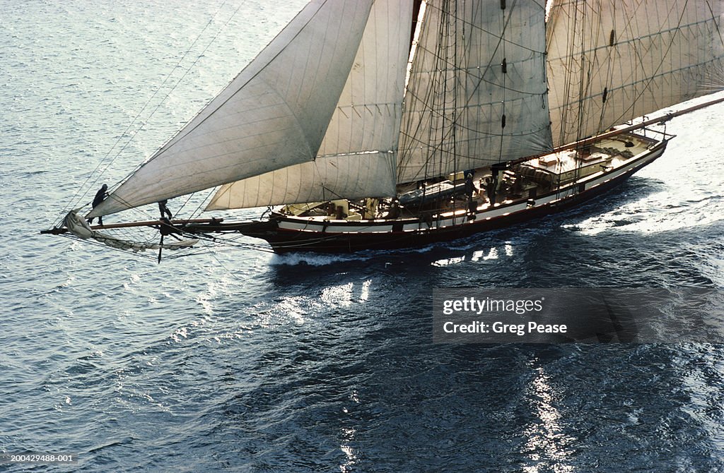 Sailing boat at sea, sunrise, aerial view