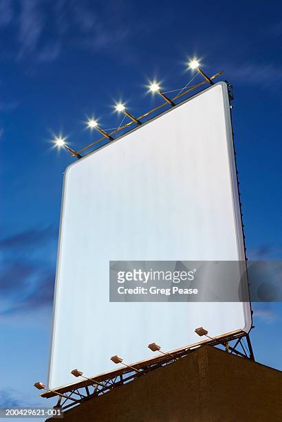 billboard on rooftop, low angle view, dusk - vertical foto e immagini stock