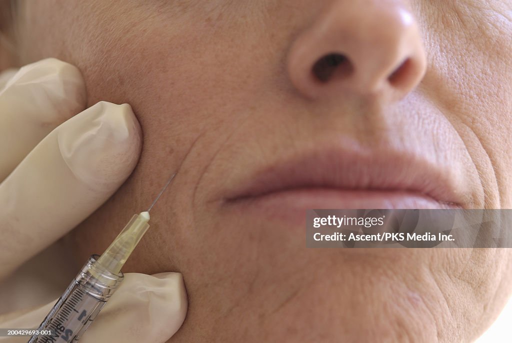 Woman receiving injection, close-up