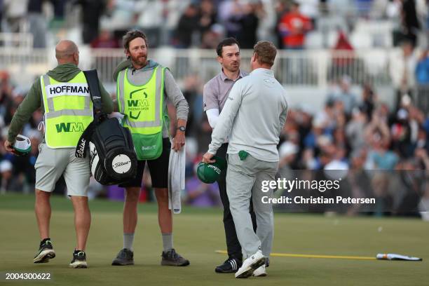 Nick Taylor of Canada shakes hands with Charley Hoffman of the United States after winning in a two-hole playoff during the final round of the WM...