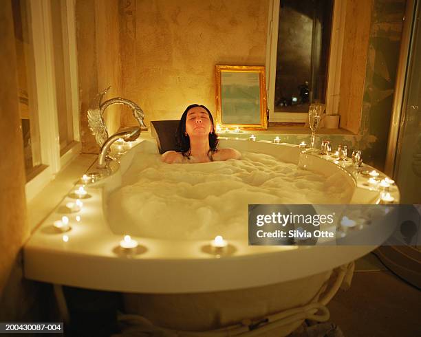 woman relaxing in bath - woman bath tub wet hair stock pictures, royalty-free photos & images