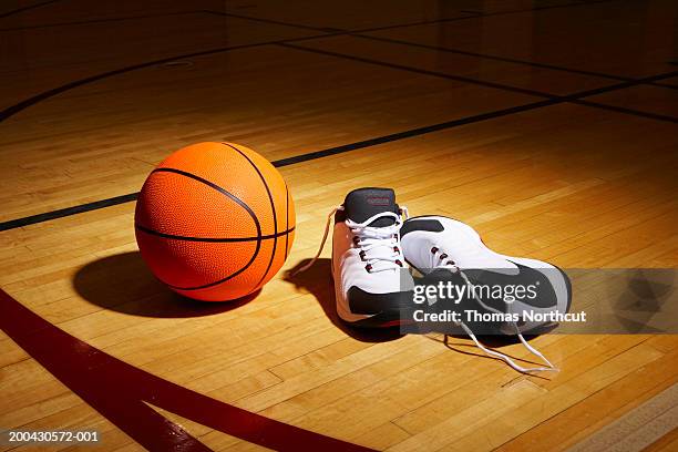 basketball and sports shoes on basketball court - basketball shoe fotografías e imágenes de stock