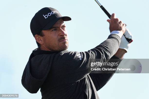 Nick Taylor of Canada plays a tee shot on the 12th hole during the continuation third round of the WM Phoenix Open at TPC Scottsdale on February 11,...