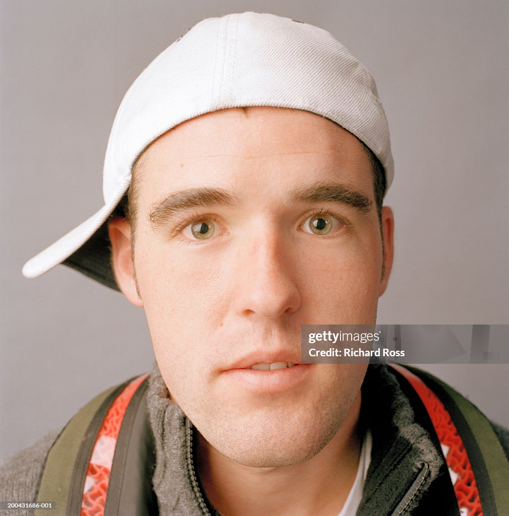 Young man wearing baseball cap, portrait