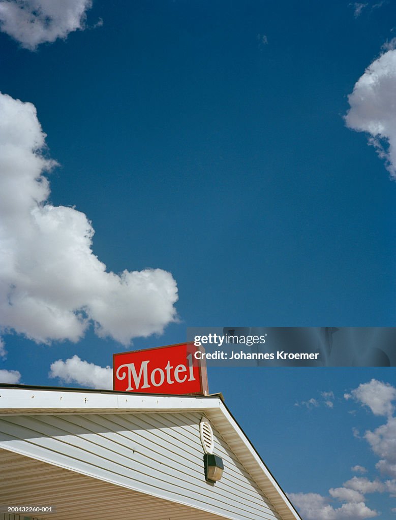 Sign on top of motel roof, low angle view