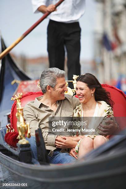 italy, venice, couple in gondola, man's arm around woman - venedig gondel stock-fotos und bilder