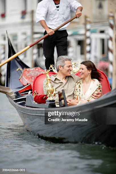 italy, venice, couple in gondola, smiling - venice gondola stock pictures, royalty-free photos & images