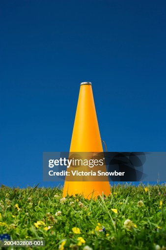 Yellow megaphone on grass Yellow megaphone on grass