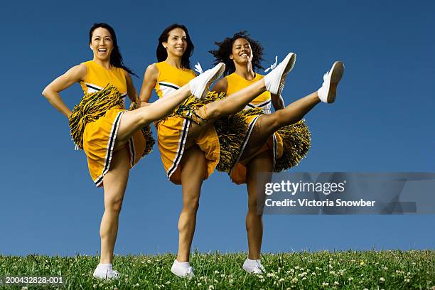 female cheerleaders doing high kicks - cheerleader high kick stock-fotos und bilder