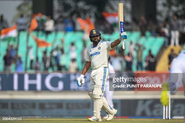 India's captain Rohit Sharma raises his bat after scoring a century during the first day of the third Test cricket match between India and England at...