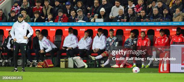 Joshua Kimmich of FC Bayern München and Teammates Sven Ulreich, Raphael Guerreiro and Thomas Müller sit on the bench, Head coach Thomas Tuchel of FC...