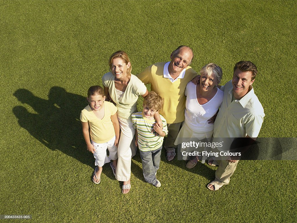 Three generational family on lawn, smiling, portrait, overhead view