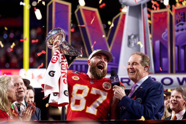 Travis Kelce of the Kansas City Chiefs celebrates with the Vince Lombardi Trophy following the NFL Super Bowl 58 football game between the San...