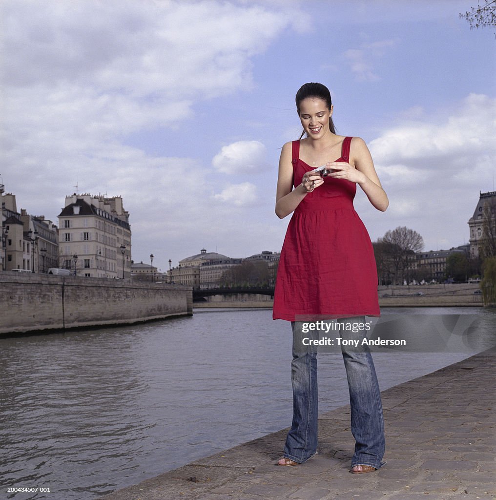 Woman wearing red dress and holding camera