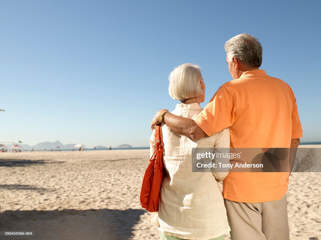 Senior couple on beach, rear view