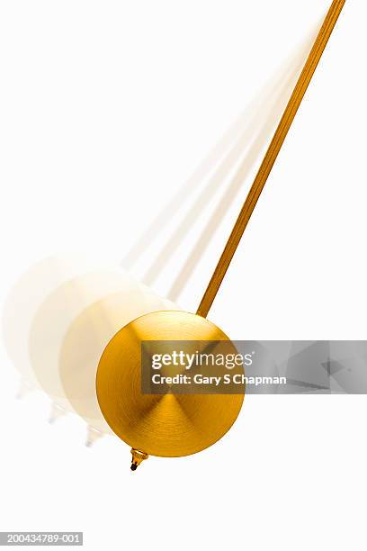 golden pendulum swinging - pendel stock-fotos und bilder