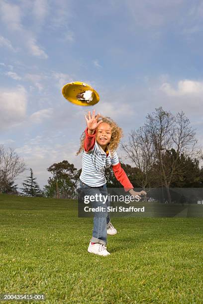 girl (4-6) throwing paper plate with cake - food fight stock pictures, royalty-free photos & images