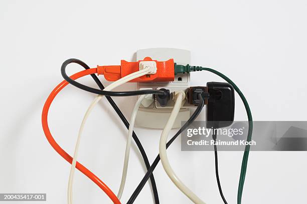 power cords in outlet - stopcontact stockfoto's en -beelden