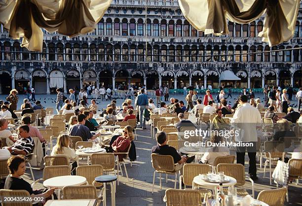 italy, veneto, venice, st. mark's square, people sitting at cafe - sidewalk cafe italy stock pictures, royalty-free photos & images
