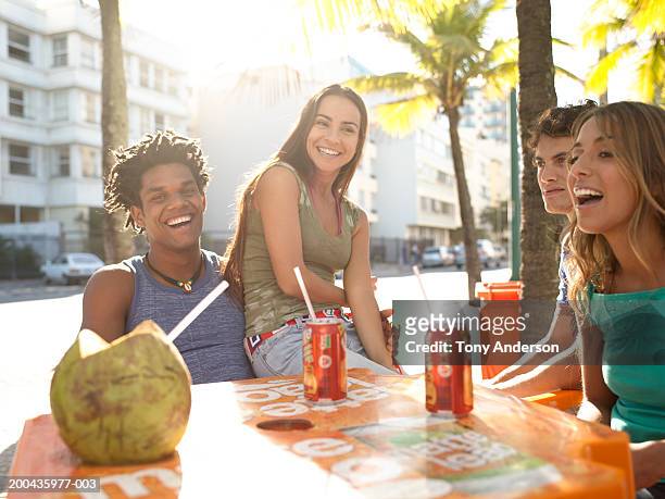 group of friends laughing at table - rio de janeiro street stock pictures, royalty-free photos & images