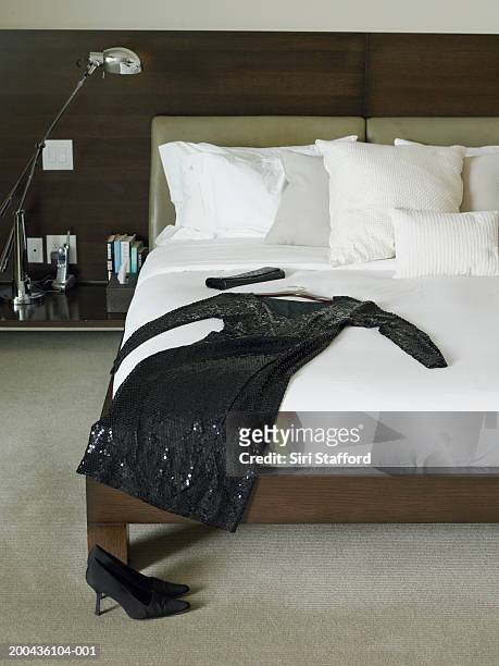 black dress and purse on bed - black sequin dress stock pictures, royalty-free photos & images