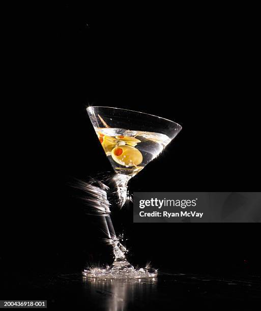martini glass shattering on floor (blurred motion) - broken martini glass stock pictures, royalty-free photos & images