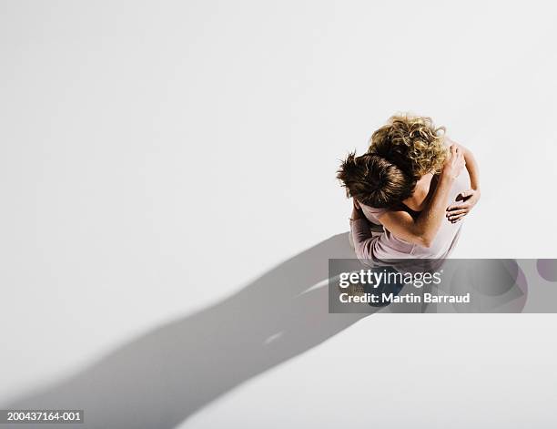 couple embracing, overhead view - romantic couple on white background stock-fotos und bilder