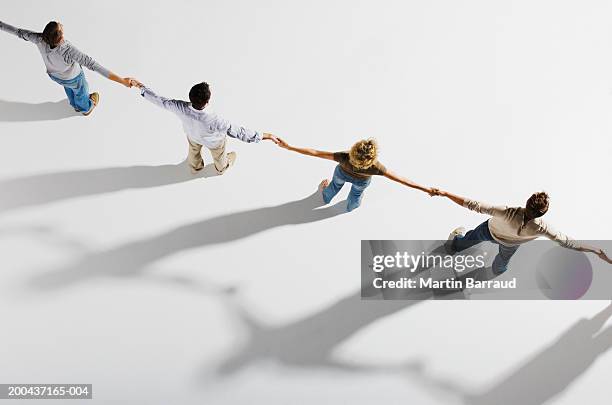 five people holding hands, standing in a row, overhead view - holding hands stock pictures, royalty-free photos & images