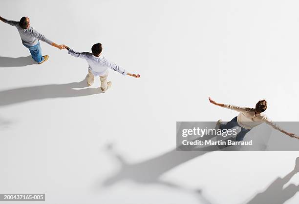 two pairs of people holding hands, gap between pairs, overhead view - people interacting on white background stock pictures, royalty-free photos & images