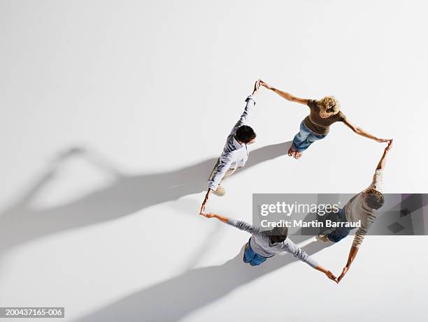 four people holding hands, forming square, overhead view - people interacting on white background stock pictures, royalty-free photos & images