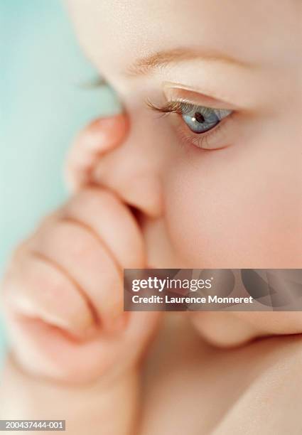 baby girl (6-12 months) sucking thumb, close-up, side view - thumb sucking stock pictures, royalty-free photos & images