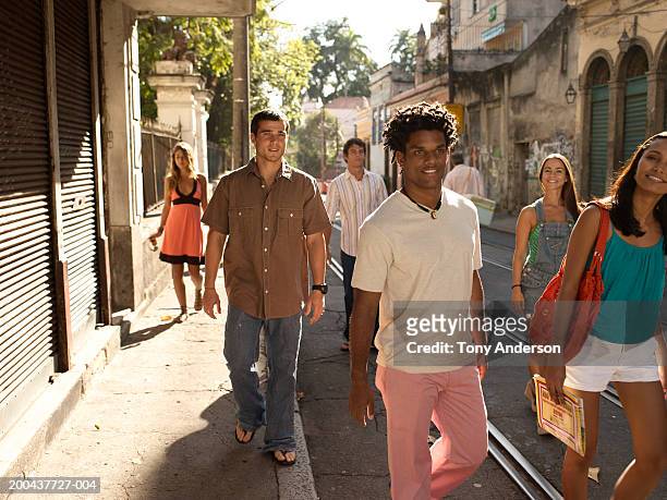 group of friends walking on street - rio de janeiro street stock pictures, royalty-free photos & images