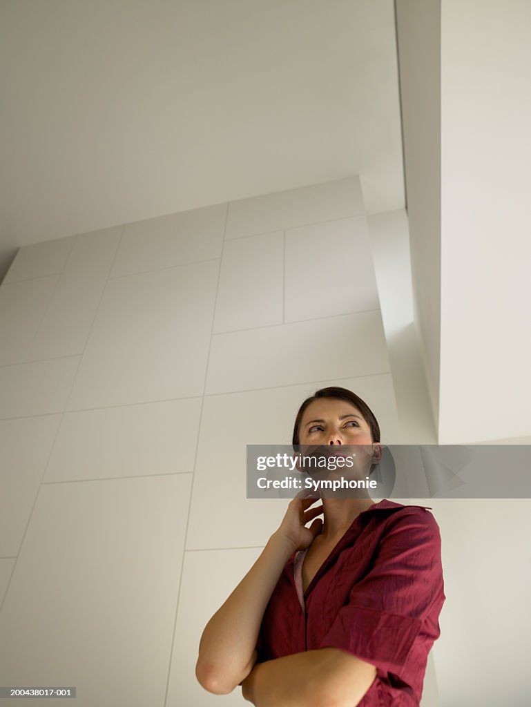 Young businesswoman looking upwards