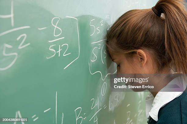 teenage girl (12-14) resting head against math equation on chalkboard - high school maths stock pictures, royalty-free photos & images