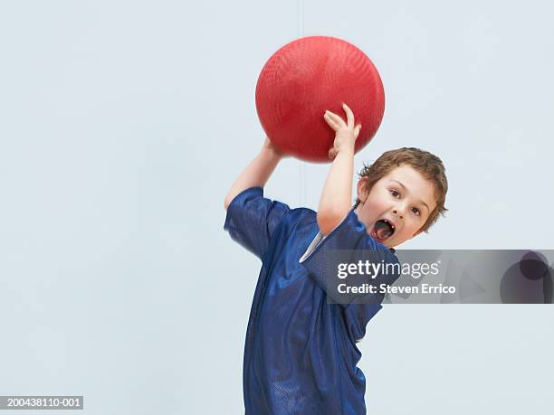 boy (5-7) throwing ball, mouth open (blurred motion) - ball werfen stock-fotos und bilder