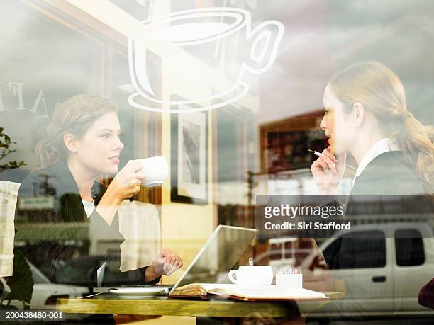 businesswomen having coffee in cafe - picking up coffee stock pictures, royalty-free photos & images