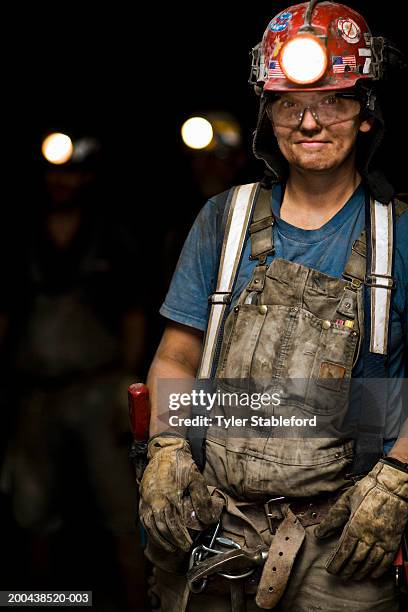 female coal miner smiling in mine, portrait, close-up - coal miner foto e immagini stock