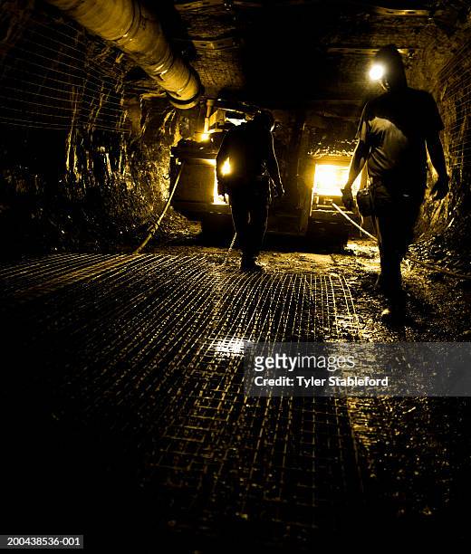 two coal miners in mine shaft (yellow tone) - mines de charbon photos et images de collection
